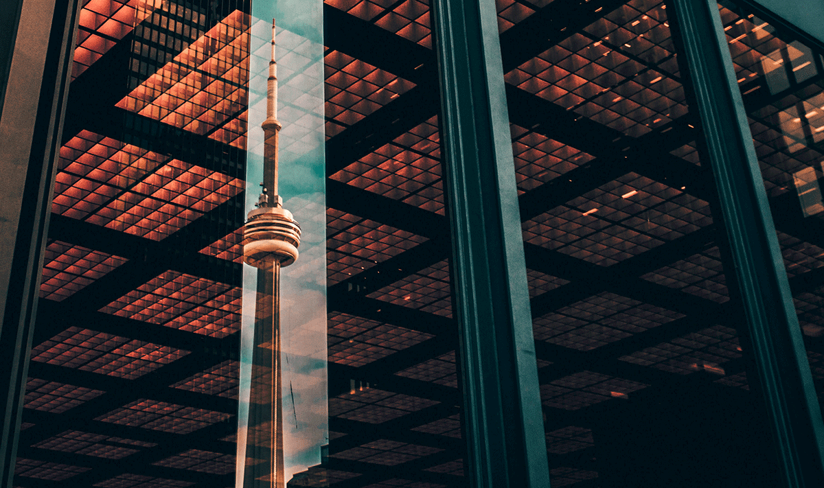 CN tower reflected in highrise window